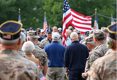 Military veterans gathering, American flag, community service, supportive atmosphere